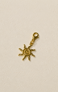 Charm sol dorado con espiral central y broche mosqueton